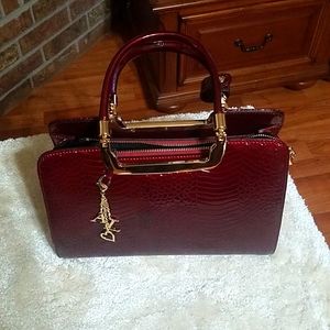 A luxurious red leather handbag, could be personalized for you.